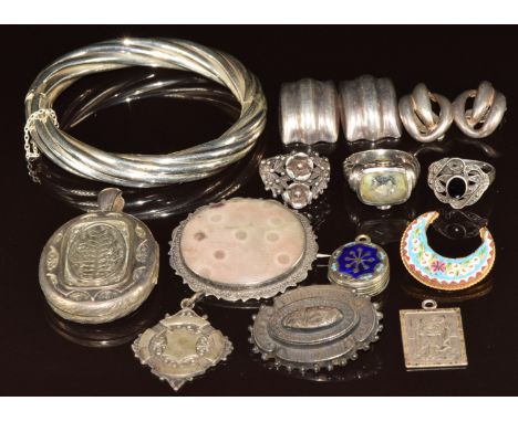 A collection of silver jewellery including bangle, fob, St Christopher, Victorian locket, brooch, two pairs of earrings, thre