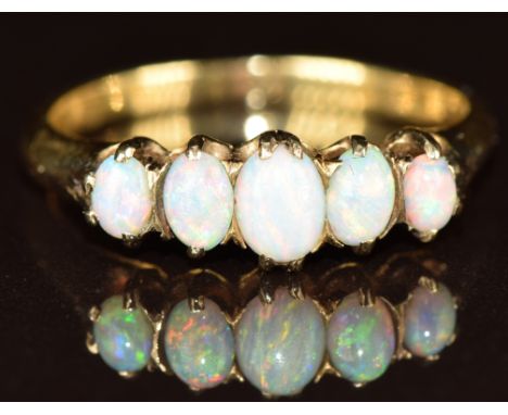An 18ct gold ring set with five opal cabochons, 2.6g, size M/N