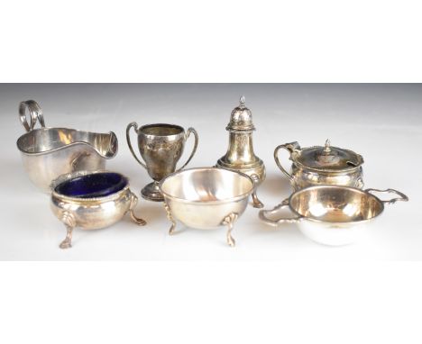 Hallmarked silver items comprising sauce boat, tea strainer on stand, salt, mustard, pepper and miniature twin handled trophy