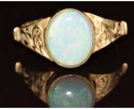 A 9ct gold ring set with an opal, with engraved shoulder decoration, 1.8g, size O