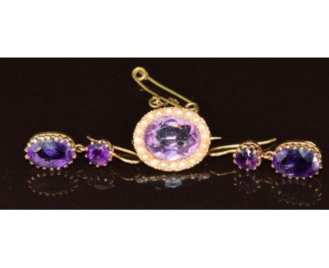 Edwardian yellow metal brooch set with an oval cut amethyst surrounded by seed pearls and a pair of 9ct gold Edwardian earrin