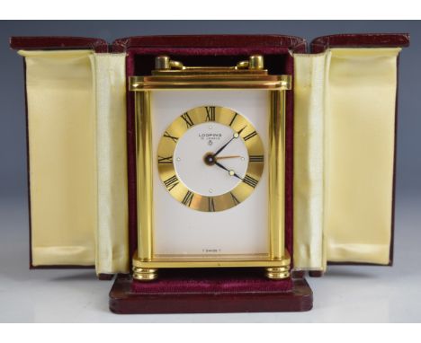 Looping Switzerland modern miniature carriage clock with brass case, raised on four turned feet, height including handle 9cm,