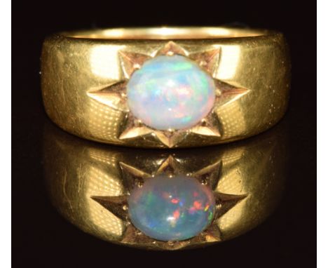 An 18ct gold ring set with an oval opal cabochon in a star setting, c1900, 11.1g, size N