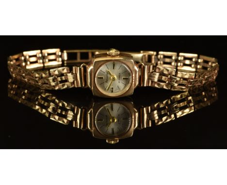 Accurist 9ct gold ladies wristwatch with gold hands, two-tone baton hour markers, silver dial and signed 21 jewel movement, c