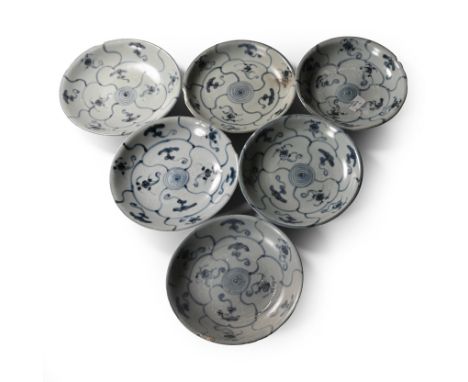 Early 19th century A.D. Comprising six shallow plates with painted flowers and tendrils to both faces.  1.4 kg total, 15.5 cm