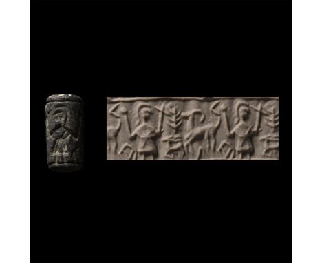 Circa 1000-800 B.C. Cylinder with cord and bead handles; accompanied by a copy of an old scholarly note, typed and signed by 
