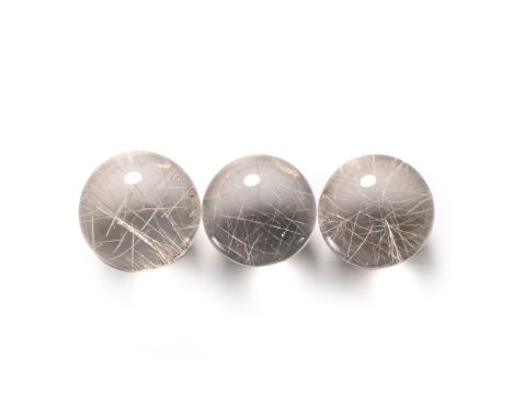  Comprising three clear quartz marbles, each with needle-like inclusions of rutile.  43 grams total, 21-22 mm (3/4 in.). [3, 