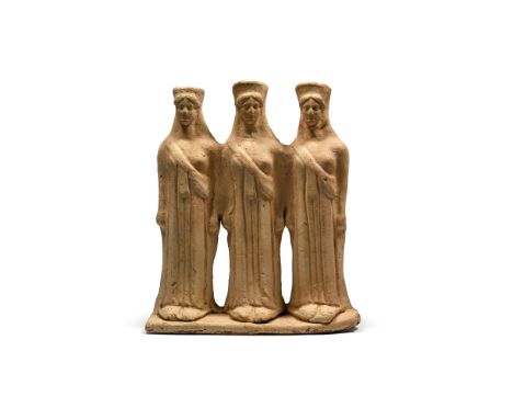 Circa 450 B.C. Comprising three standing korai on a rectangular base, each wearing a chiton and a himation draped diagonally 