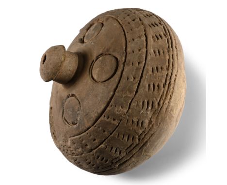 9th-11th century A.D. Piriform in profile with narrow point and domed mouth; impressed annulets surrounding the neck, two wid