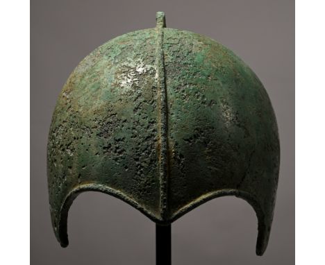 7th-6th century B.C. Raised from a single sheet with rounded skull and semi-circular cut-outs for the eyes with raised rims, 