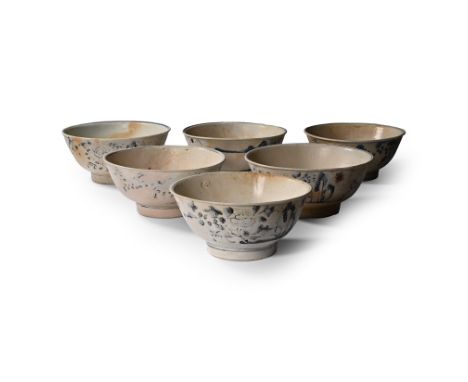 Early 19th century A.D. Comprising six wide bowls with rolled rims, each with painted floral and linear decoration.  2.52 kg 