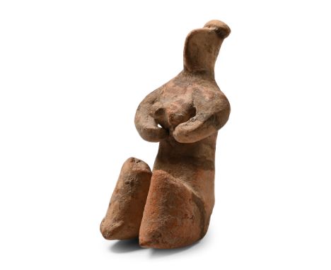 6th millennium B.C. Modelled in the round crouching female figure with hands supporting the breasts, knees drawn up, pinched 