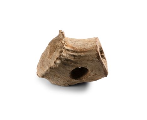 Neolithic Period, 4000-2300 B.P. Carved from a large bone fragment and drilled through the centre.  227 grams, 10.4 cm (4 1/8