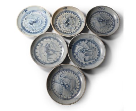 Early 19th century A.D. Comprising six shallow plates with painted feather decoration, scrolls below the rim.  1.79 kg total,
