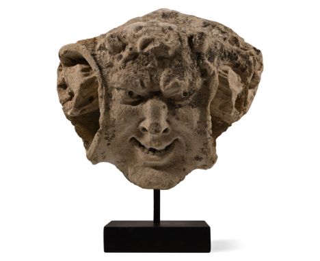 Circa 15th century A.D. Modelled with a threatening expression, his half-open mouth visibly contracted into an evil grin with