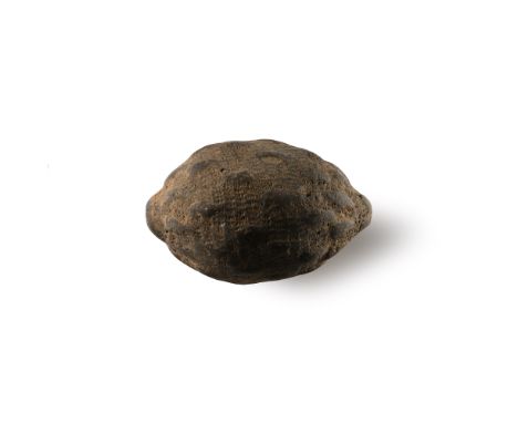 9th-11th century A.D. Piriform in profile with narrow point; the body decorated with raised teardrop-shaped bosses and impres