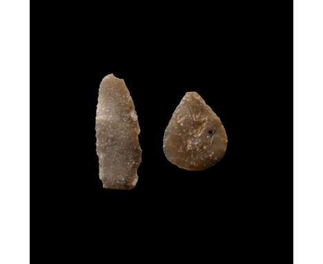 Neolithic Period, 4th-3rd millennium B.C. Comprising two knapped arrowheads, both with some retouching.  4.59 grams total, 25