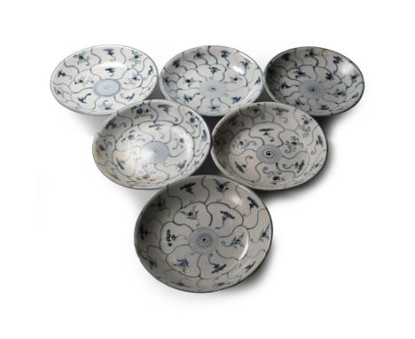 Early 19th century A.D. Comprising six shallow plates with painted flowers and tendrils to the upper and lower face.  2.23 kg