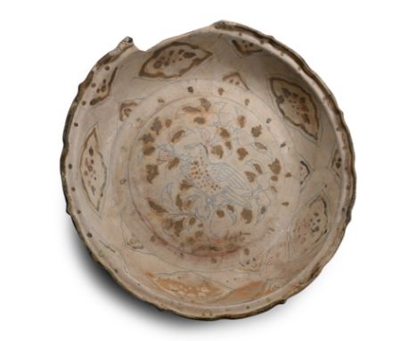15th century A.D. A wide plate with scalloped rim, the inner face with a singing bird seated on a flowering branch, petals to