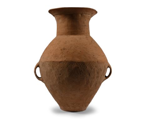 Neolithic Period, 3rd millennium B.C. Biconvex in profile with flared mouth, lateral strap handles at the equator.  4.2 kg, 4
