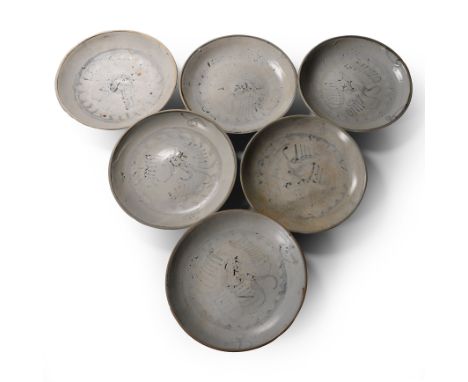 Early 19th century A.D. Comprising six shallow plates with feather design to the upper face.  1.85 kg total, 18 cm each (7 1/