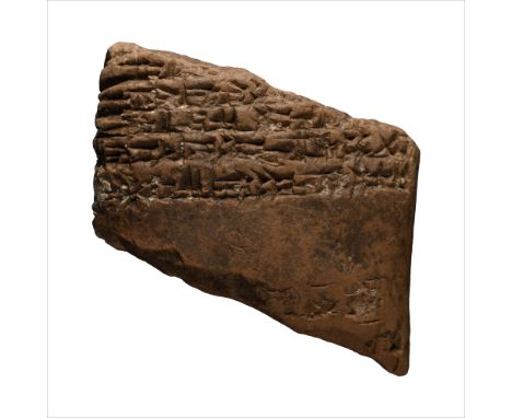 Circa 2000-1600 B.C. Fragment of a pillow-shaped tablet, cuneiform text to both broad faces and one edge.  58.8 grams, 50 mm 