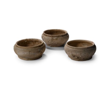 15th century A.D. Comprising three shallow dishes with rolled rims, two with painted petal decoration. Cf. similar vessels in