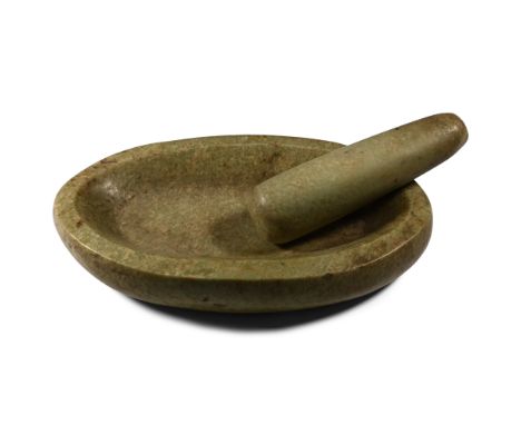 Circa 17th century A.D. Comprising a shallow mortar, ellipsoid in plan with rounded rim; tapering pestle with broad grinding 