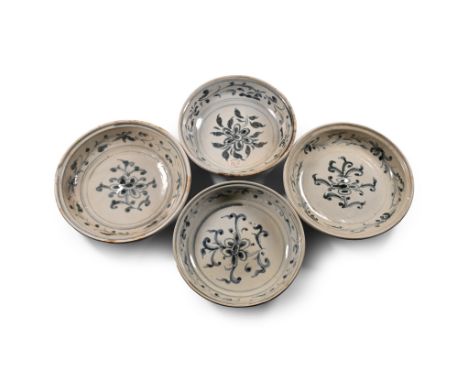 15th century A.D. Comprising four wide plates with stepped rims, each with painted floral decoration to the inner face and st