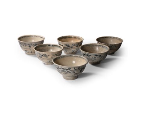 15th century A.D. Comprising six bowls with painted flowers and tendrils to the outer face, the inner face with a central flo
