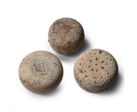 15th century A.D. Comprising three powder boxes, two with painted floral motifs and tendrils, one with a geometric medallion 