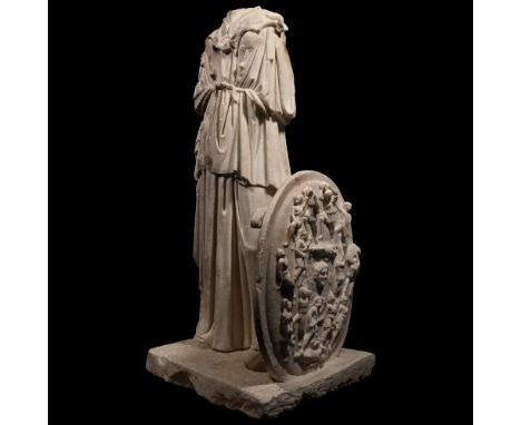 2nd century A.D. Modelled in the round, the goddess standing on a rectangular base; wearing a flounced floor-length robe drap