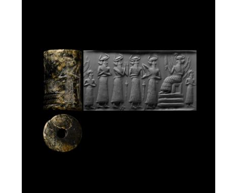 Circa 2334-2279 B.C. Finely engraved with a religious scene, sun god Shamash seated on a throne with his feet resting on a pa