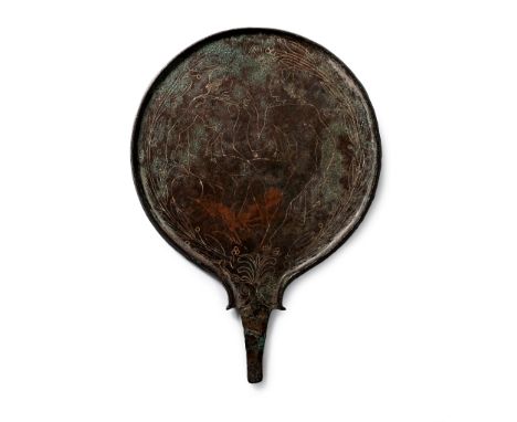 Late 4th-3rd century B.C. Discoid mirror with a short tang to accept an organic handle, the reverse with a palmette above the
