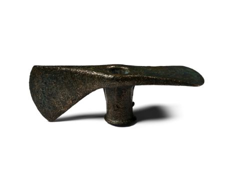 2nd-early 1st millennium B.C. An adze-axe head with central shaft hole and curved blades, flange to socket. Cf. Christie's, T