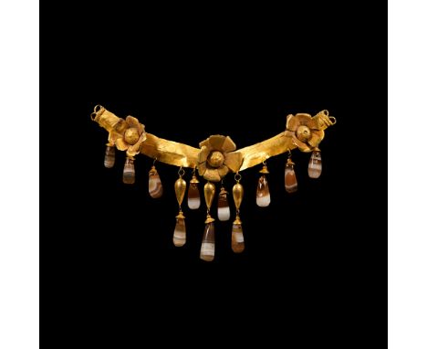 Circa 3rd century B.C. Crescentic frontal panel from a necklace or collar; sheet gold band with slight carination, lightly in