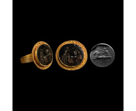 20th century A.D. Onyx cloison with intaglio image of a biga in profile with trident beneath and driver brandishing a sword. 
