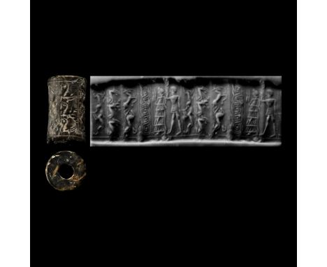 Circa 1800-1700 B.C. Cylinder with cord and bead handles; accompanied by a copy of an old scholarly note, typed and signed by