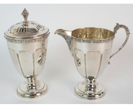 A silver sugar castor and cream jug set by Fenton, Russell & Company Limited, Birmingham 1939, of tapering cylindrical form w