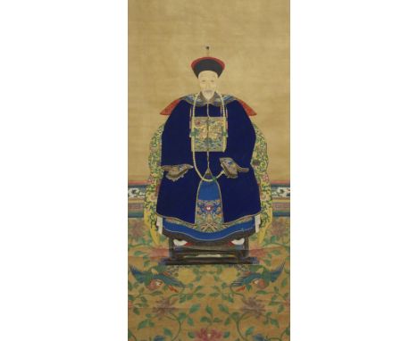 A Chinese ancestral portrait of a Mandarin seated on a chair resting on a carpet of phoenix in flight, watercolour on silk, 1