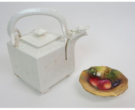 A Royal Worcester teapot designed by James Hadley, of square form with dragon handle, in blanc de chine glaze with flowers an