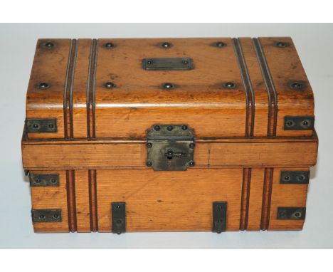 A Victorian oak and brass bound humidor modelled as a cabin trunk with hinged lid and brass handles (one lacking), fitted int
