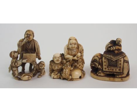 A Japanese ivory netsuke with a drummer seated on an elephant,4cm high, a netsuke of two figures with toad, signed and a carv