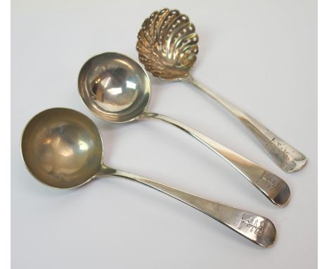 A pair of George III silver sauce ladles by William Sumner, London 1787, with crested finials, with a Victorian silver sifter