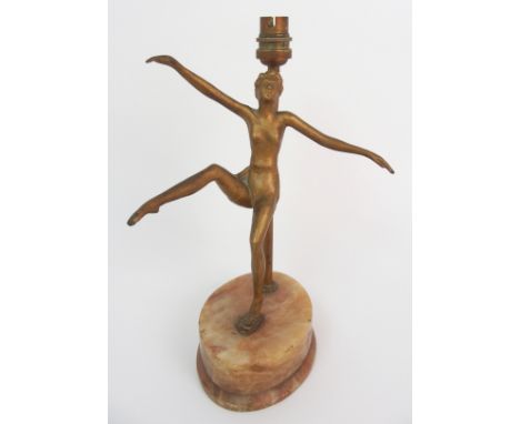 An Art Deco figural lamp modelled as a gilded dancing woman, upon oval onyx base, 28cm high