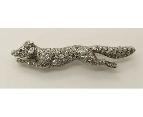 A white metal ruby and diamond fox brooch set with estimated approximately 2cts of pave set diamonds, the eye set with a ruby