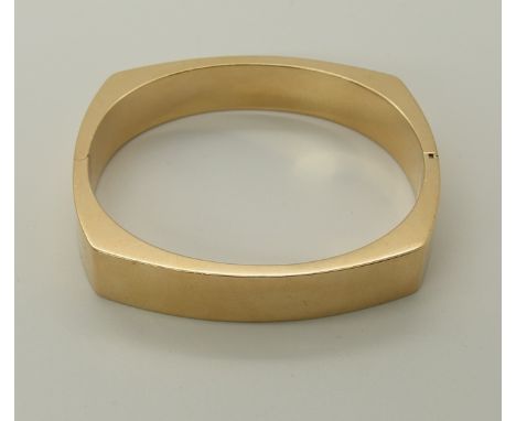 A 14ct gold bangle signed Kala of retro design, inner dimensions approx 5.8cm x 5.2cm, width 1.1cm, weight 23.6gms