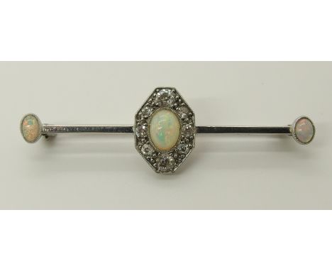 A white metal opal and diamond bar brooch the old cut diamonds have a combined estimated approx weight of 0.40cts, central op