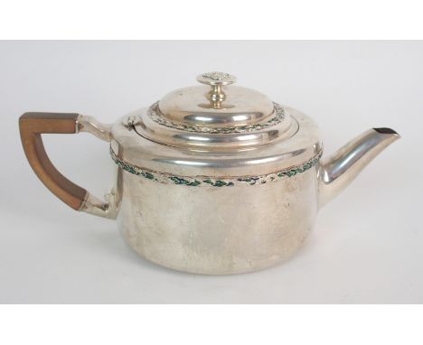 An Art Nouveau silver teapot by Liberty & Company, Birmingham 1909, of cylindrical form with floral enamel borders, the teapo