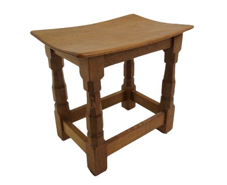 A Robert 'Mouseman' Thompson oak dish-top stool the curved seat on four octagonal baluster legs joined by stretchers, with ca